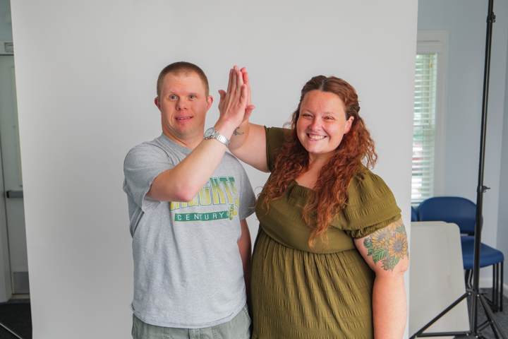 A young man and a woman share a high five