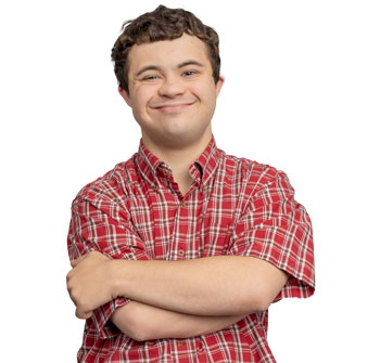 Target Community Participant Michael, wearing a red checked shirt and brown hair stands with his arms crossed smiling at the camera.